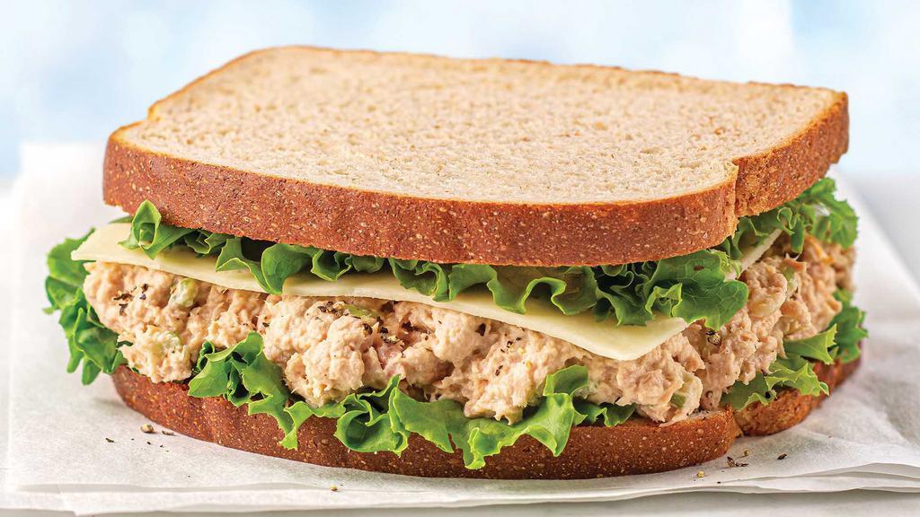 Tuna Salad Sandwich · Tuna Salad, fresh leaf lettuce, Havarti cheese, and black pepper on organic white bread.