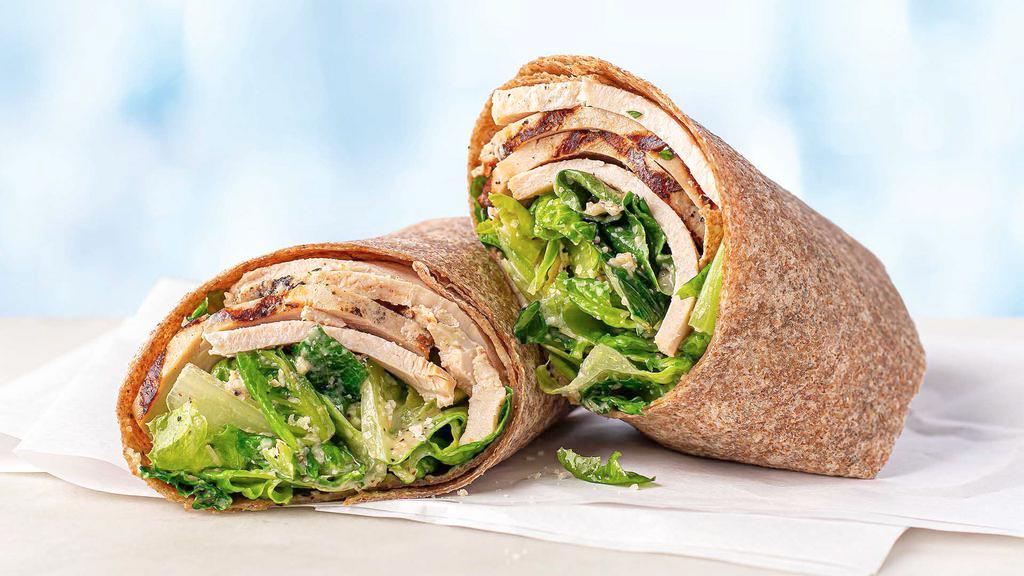 Chicken Caesar Wheat Wrap · Juicy, tender grilled lemon garlic chicken breast, grated Imported Parmigiano Reggiano (aged 24 months), fresh romaine lettuce, creamy Caesar Dressing, and a dash of black pepper, served in a wheat wrap.