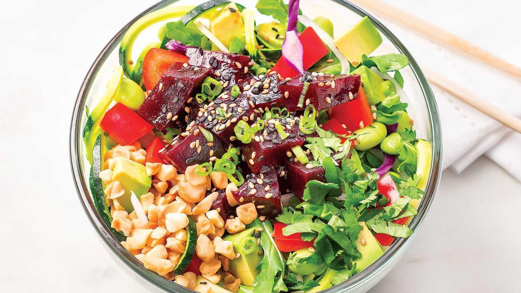 Beet & Macadamia Poke Salad · Cooked beets, red cabbage, and avocado with sweet & spicy poke sauce, macadamia nuts, cilantro, scallions, and toasted sesame seeds on a bed of zucchini noodles and arugula..