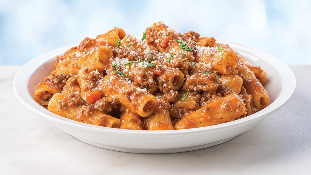 Rigatoni Bolognese · Ready to heat, our traditional Bolognese sauce made with beef, pork, and veal, is served over rigatoni with imported extra virgin olive oil and grated Parmigiano Reggiano cheese. Heating instructions: Loosen lid, microwave 2 minutes on high, stir, and serve.