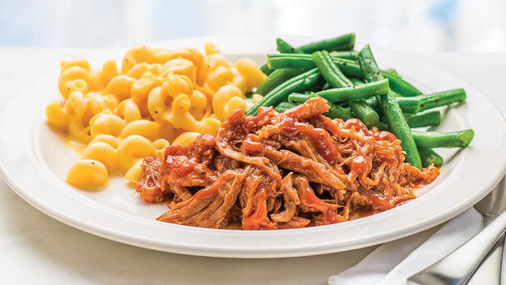Bbq Pulled Pork Meal · Ready to heat, our tender pulled pork is topped with BBQ sauce and served with seasoned green beans and creamy macaroni & cheese.