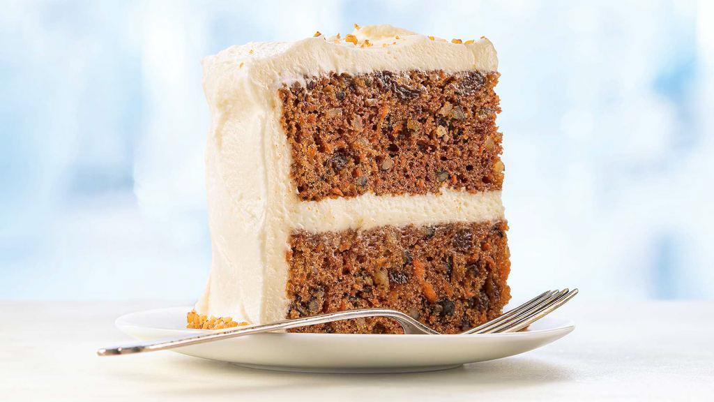 Ultimate Carrot Cake Slice · Incredibly moist cake with carrots, walnuts, and golden raisins, finished with cream cheese icing and toasted walnuts..