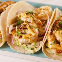 Grilled Shrimp Tacos · 2 grilled shrimp tacos with a cabbage slaw, pico de gallo, and sour cream in a flour tortilla.