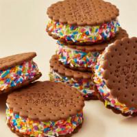 Deluxe Flying Saucers® Rainbow Sprinkles (6-Pack) · Soft ice cream rolled in sprinkles and sandwiched between two Flying Saucer® chocolate wafer...