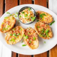 1207. Potato Skins · Jack and Cheddar Cheese, Bacon Bits, Sour Cream and Green onion.