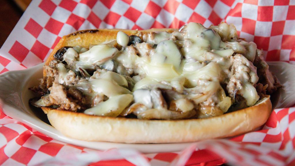 1241. Philly Cheese Steak Sandwich · 1/4 lb of sliced grilled Rib Eye, smothered with Mushrooms, Onion, Swiss Cheese, and Mayo served on a French Roll. Add a side of fries, tots, onion rings or a salad for additional cost.