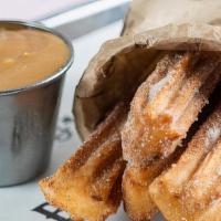 Churros · Served with dulce de leche and chocolate sauce (NOT Gluten-free)