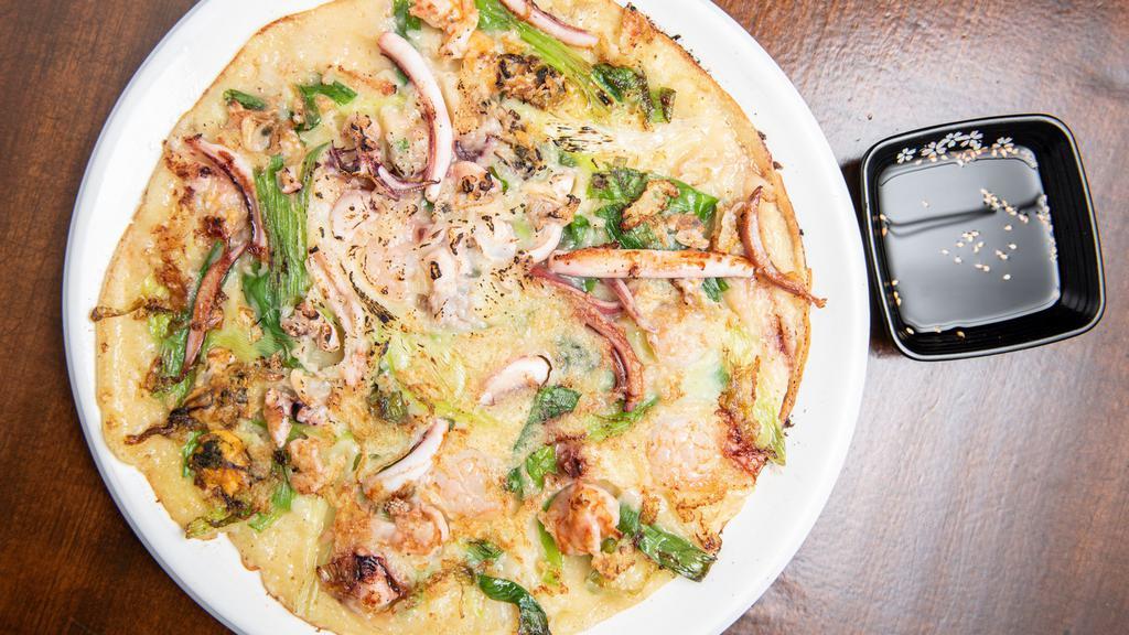 Scallion Pancake With Seafood(해물파전) · Crispy and chewy pancake with scallion, mixed seafood (squids, mussels, shrimps) and vegetable.