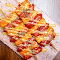 Rice Cake & Sausage Skewers(소떡) · Rice cake and sausage skewers with Korean sweet and spicy sauce.
