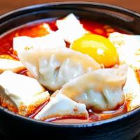 Dumpling Soft Tofu Stew(만두순두부) · Spicy. soft tofu stew with Dumpling, vegetables, soft tofu and egg in spicy broth. Served wi...