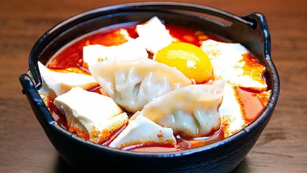 Dumpling Soft Tofu Stew(만두순두부) · Spicy. soft tofu stew with Dumpling, vegetables, soft tofu and egg in spicy broth. Served with rice.