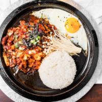 Chadol Chulpan · Steamed rice topped with spicy beef, fried egg and kimchi cooked on a hot plate; served sizz...