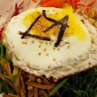 Bibimbap · Assortment of lightly sauteed vegetables, ground beef and fried egg served with rice.