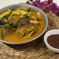 Ox-Tail Kare Kare · Ox-tail, beef tripe, tropical vegetables in a peanut annatto sauce.