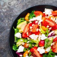 Italian Mixed Salad · Fresh salad made with Tomatoes, onions, and lettuce, topped with an Italian vinaigrette. Ser...