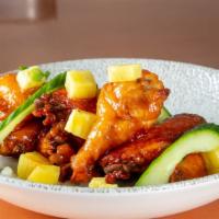 Caribbean Chicken Wings · Sweet Heat. House caribbean, sauce, grilled pineapple, scallion, cucumber.
