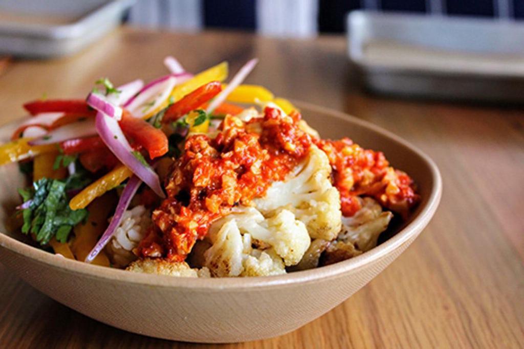 Cauliflower Bowl · roasted cauliflower topped with a romesco sauce. contains: garlic, nuts, onion