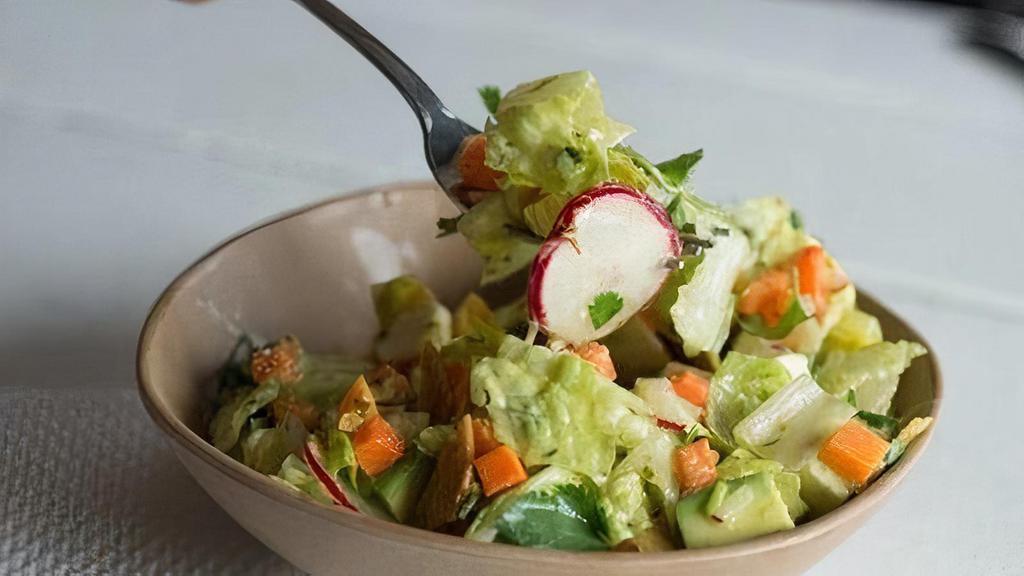 Chopped Salad · chopped romaine, pickled carrots, crushed tortilla chips, queso fresco, cilantro, avocado, and a cilantro-lime vinaigrette. contains: dairy, garlic, onion, refined sugar