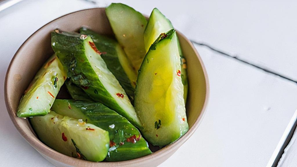 Spicy Cucumber Salad · cucumbers tossed in garlic, red pepper flakes, cilantro and rice wine vinegar. contains: garlic + refined sugar