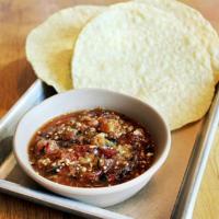 Salsa Roja + Chips · a spicy red salsa w/ charred veggies + tomatillos. contains: garlic + pineapple
