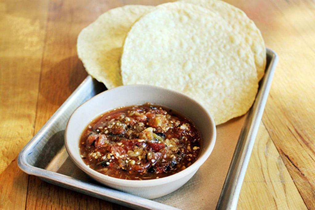 Salsa Roja + Chips · a spicy red salsa w/ charred veggies + tomatillos. contains: garlic + pineapple