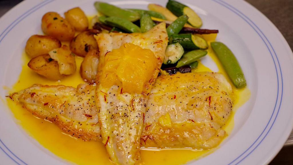 Wild Stripped Bass Antibes-Style  · with sauce of saffron, orange, Pernod, lobster stock, with sautéed spinach &  roasted potatoes