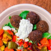 Falafel Salad · Vegan, gluten free. Our signature green falafel fried to perfection over mixed spring green ...