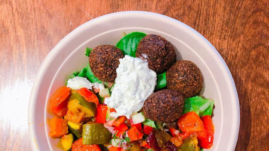 Falafel Salad · Vegan, gluten free. Our signature green falafel fried to perfection over mixed spring green salad, Israeli salad and Foreverything pickles.