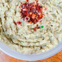 Baba Ghanoush (8 Oz) · Vegan. Smoky eggplant dip with a sprinkle of red pepper flakes, served with pita.