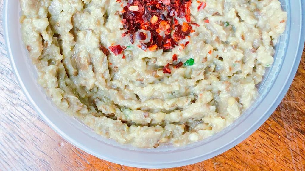 Side Of Baba Ghanoush · Vegan, gluten free. Smoky eggplant dip with a sprinkle of red pepper flakes.