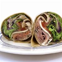 The American Wrap · Delicious wrap made with slices of ham, turkey, American cheese, shredded lettuce, tomatoes,...