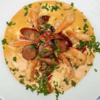 Shrimp & Grits · A classic with stone ground grits, andouille sausage, mushrooms, peppers, and a light cream ...