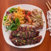 Kalbi · Short rib marinated in signature sauce and grilled. Includes a bed of white rice and four si...