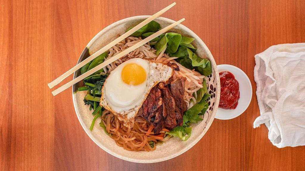 Bibimbap · Served in a bowl, rice at the bottom, your choice of protein (tofu or bulgogi), veggies, gochujang, kimchi, and topped with a soft fried egg.
