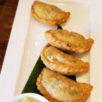 Curry Puffs (4) · 4 pieces minced chicken potato and onion in puff pastry w/ cucumber salad.