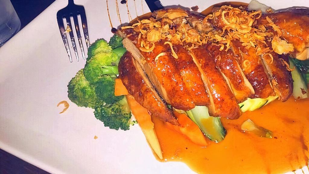 Tamarind Duck · Crispy Long Island duck with tamarind sauce on bed of steamed mixed vegetables.