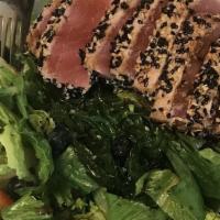 Ahi Tuna · Served over organic spring mix, pickle ginger, and wasabi, fresh fruit and topped with a soy...