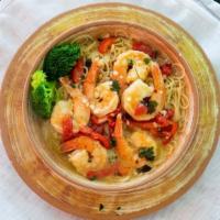 Shrimp Scampi · Jumbo shrimp served over a bed of linguine in a lemon butter wine sauce with fresh red peppe...