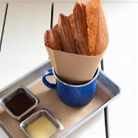 Churros · fried dough tossed with sugar and cinnamon, served with chocolate and vanilla sauces. contai...