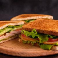Turkey Club Sandwich · A tasty sandwich of sliced turkey, fresh lettuce, tomato, sizzling bacon, avocado, and mayon...