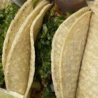 Carnitas Taco · Roasted pork, salsa verde, cilantro and onions.