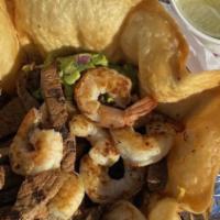 Xela Burrito · Sautéed shrimp, steak, rice, beans, guacamole and pico de gallo.