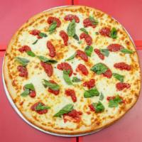 Margherita Pizza · Plum tomatoes, fresh mozzarella, basil, garlic and olive oil.
