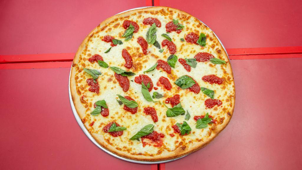 Margherita Pizza · Plum tomatoes, fresh mozzarella, basil, garlic and olive oil.