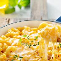 Mac & Cheese · Cooked Macaroni pasta served in a delicious cheddar cheese sauce.