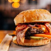 Bacon Cheeseburger · Juicy beef patty topped with crispy bacon, cheese, lettuce, tomatoes, onions, and pickles.