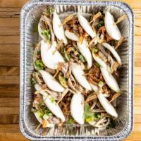 Peking Duck Buns · Per piece. Steamed buns filled with peking duck, hoisin sauce, cucumber, scallion, and cilan...