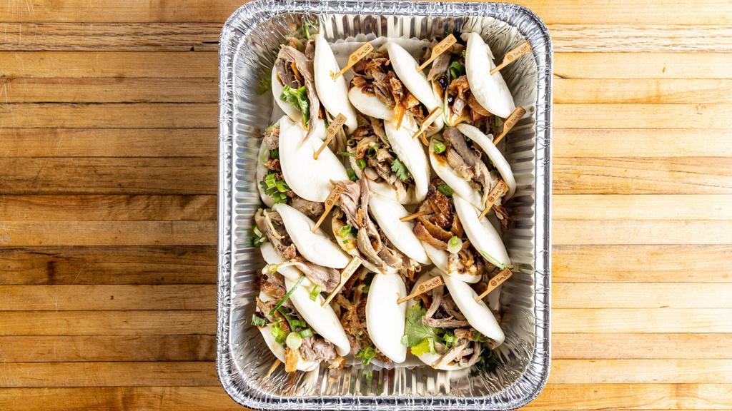 Peking Duck Buns · Per piece. Steamed buns filled with peking duck, hoisin sauce, cucumber, scallion, and cilantro.