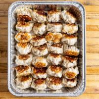 Pan Fried Pork And Shrimp Dumplings · Per piece. Pan fried shrimp and pork dumplings in a homemade wheat wrapper.