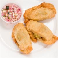 Curry Puffs 3 · Ground chicken with potato, onion, herbs and spices.